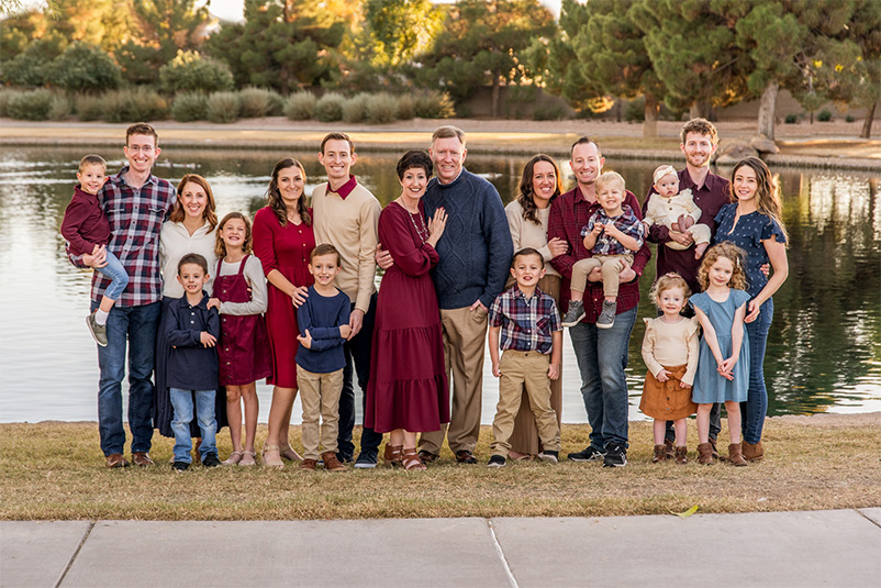 Michael Cowan's family poses in front of a lake