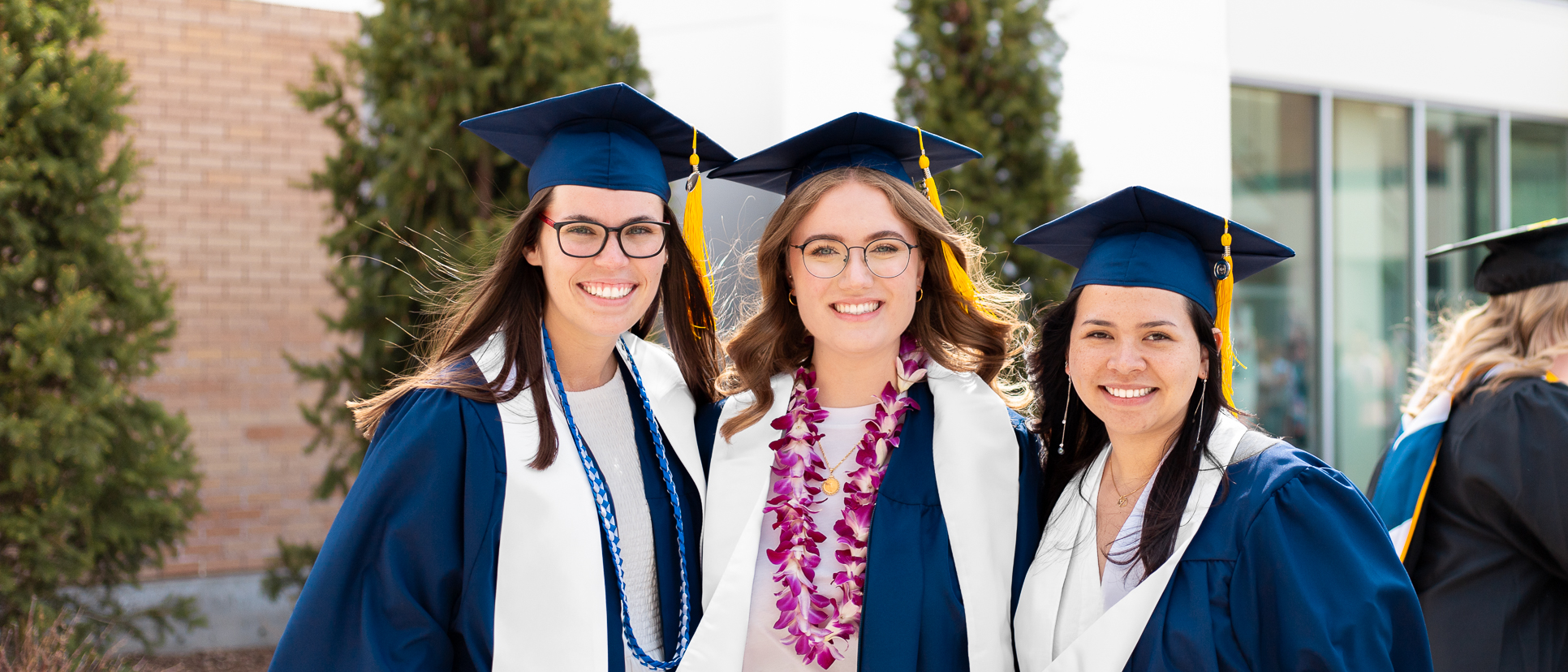 Woman graduating college in blue robes