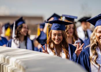 student posing at graduation