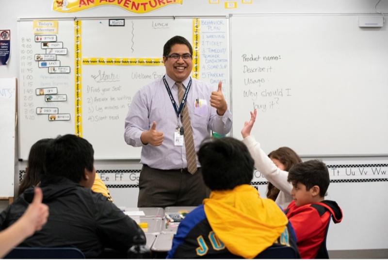 Male teacher is a classroom teaching elementary school students