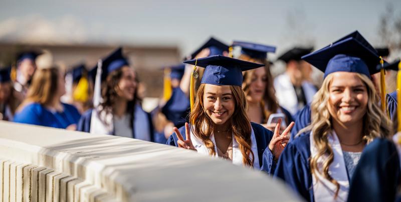 student posing at graduation