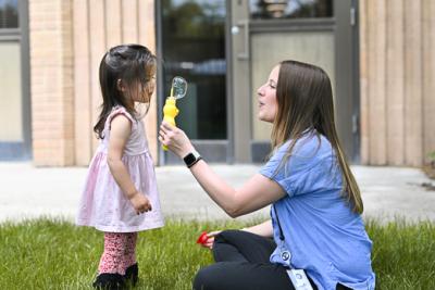 a woman playing with a child