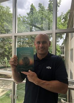 Kawika Allen holding textbook