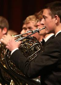 young men playing french horn