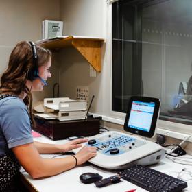 Woman smiling while using a control panel